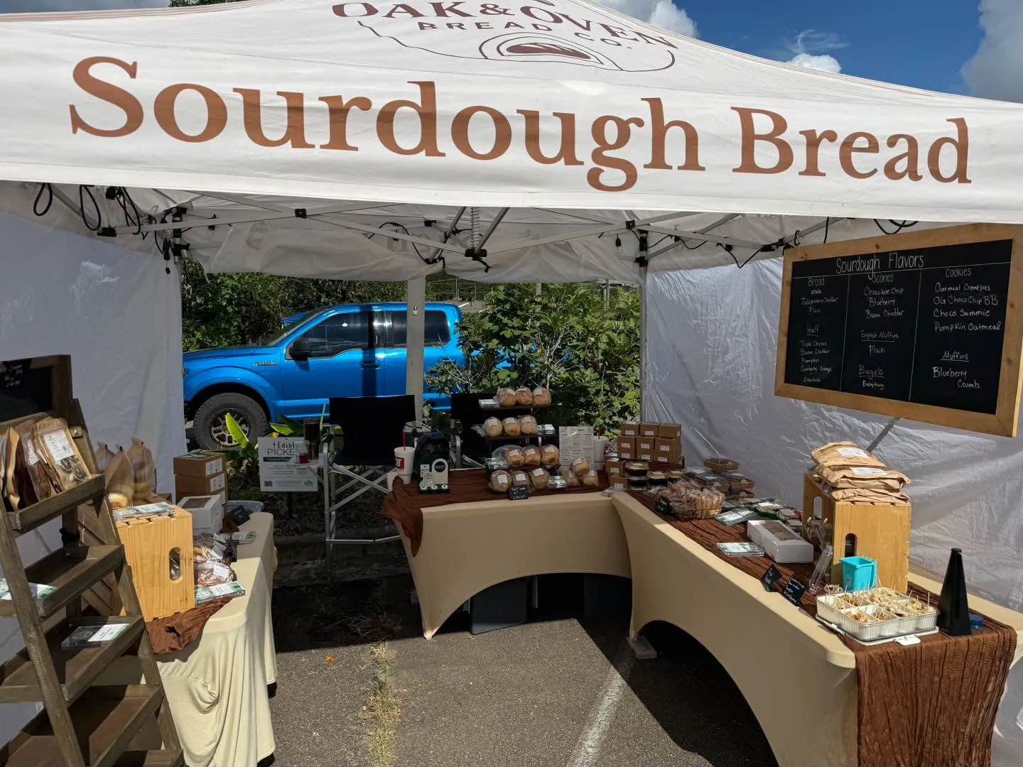 The Oak & Oven Bread Co. market tent, with sourdough loaves, scones, bagels and cookies on display