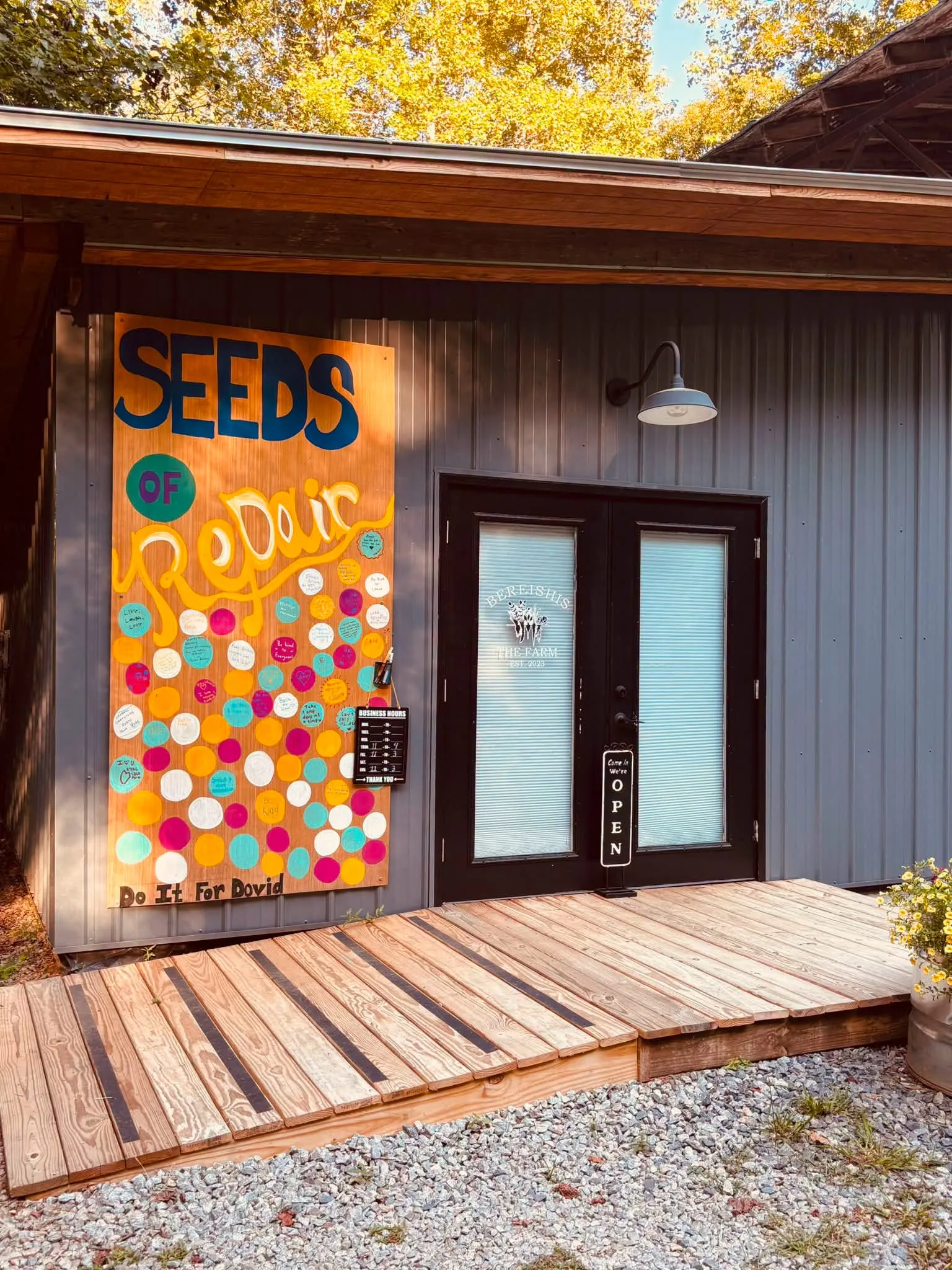 The Bereishis Farms storefront on Chatsworth Highway, with black double doors and the farm's posted business hours