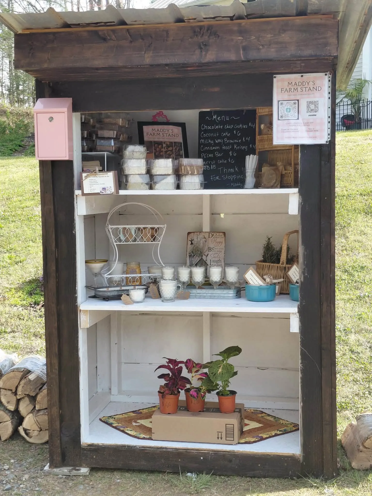 Maddy's Farm Stand shelves stocked with baked goods, handmade candles and small potted plants
