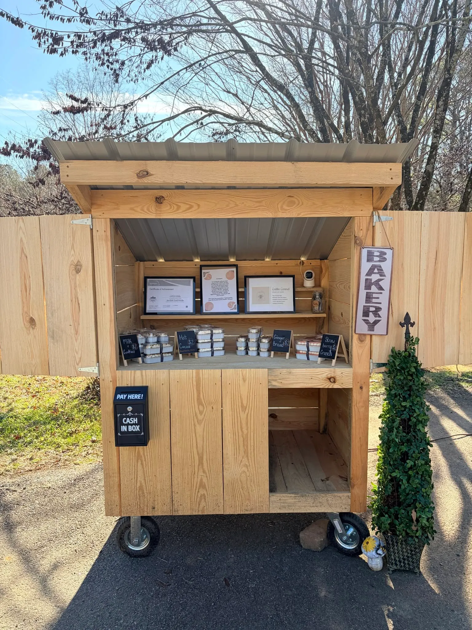 The Sweet Bee Bakery stand, packaged cookies and treats tagged with prices
