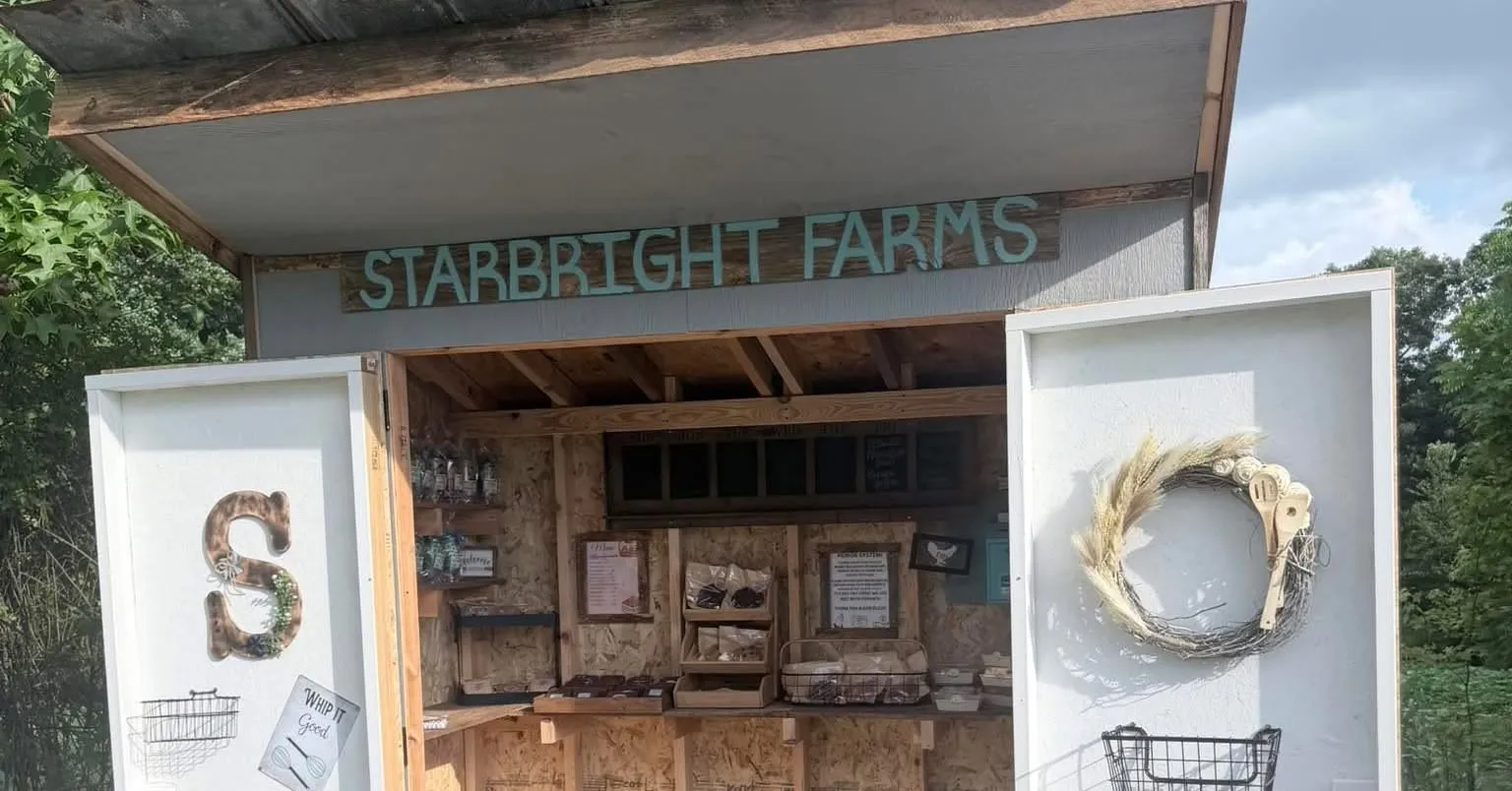 The Starbright Farms stand, shelves stocked with packaged bakes and a wreath by the door