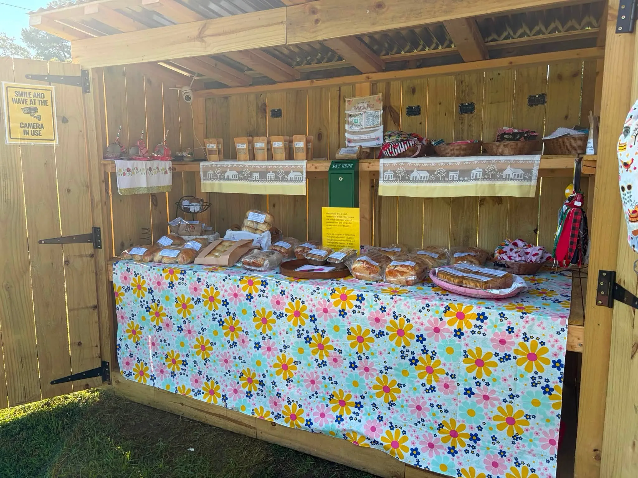 The Magnolia Sunrise Farm-stand shelves stocked with fresh bread and handmade goods